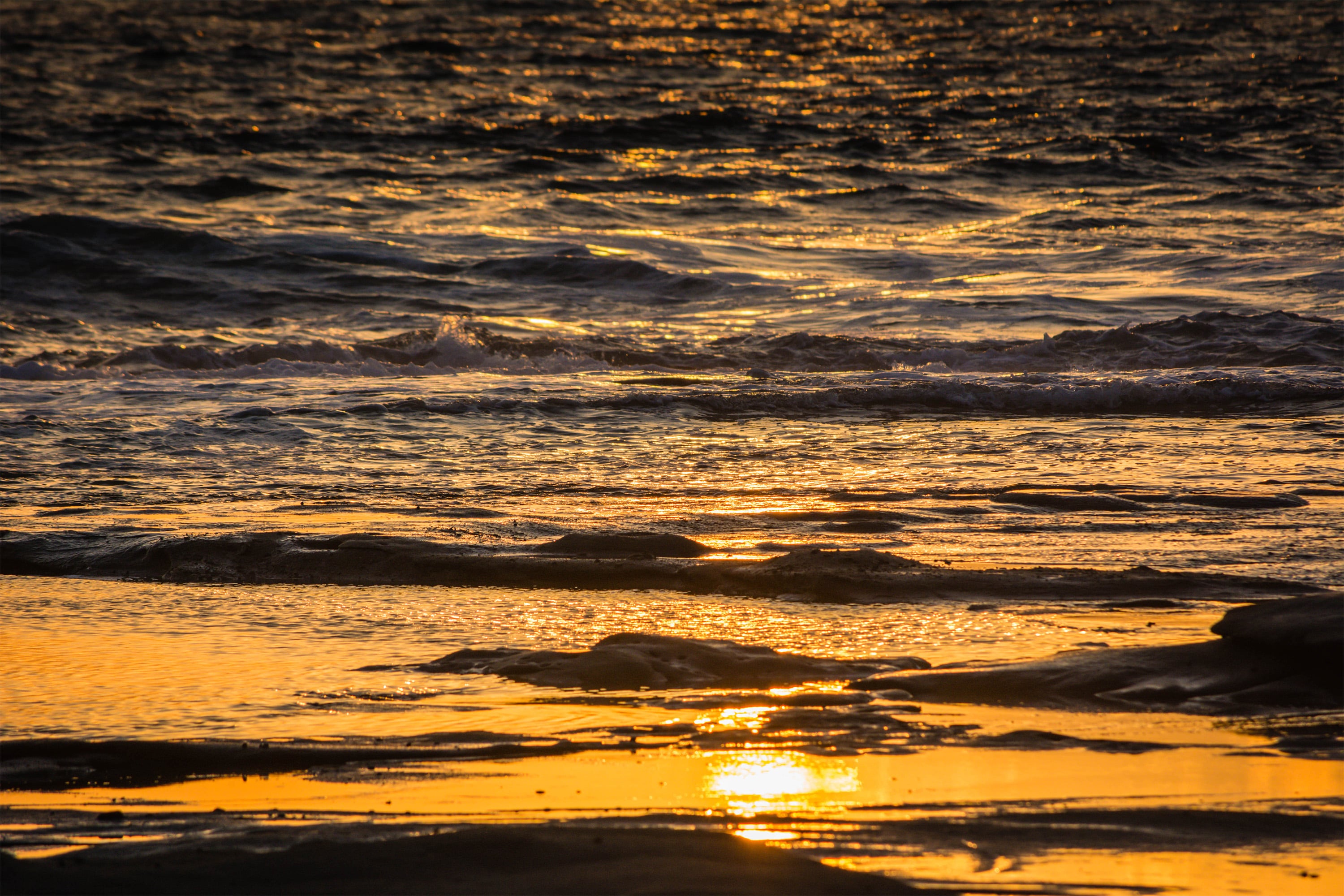 Sunrise reflected in water at Shelly Beach, Queensland