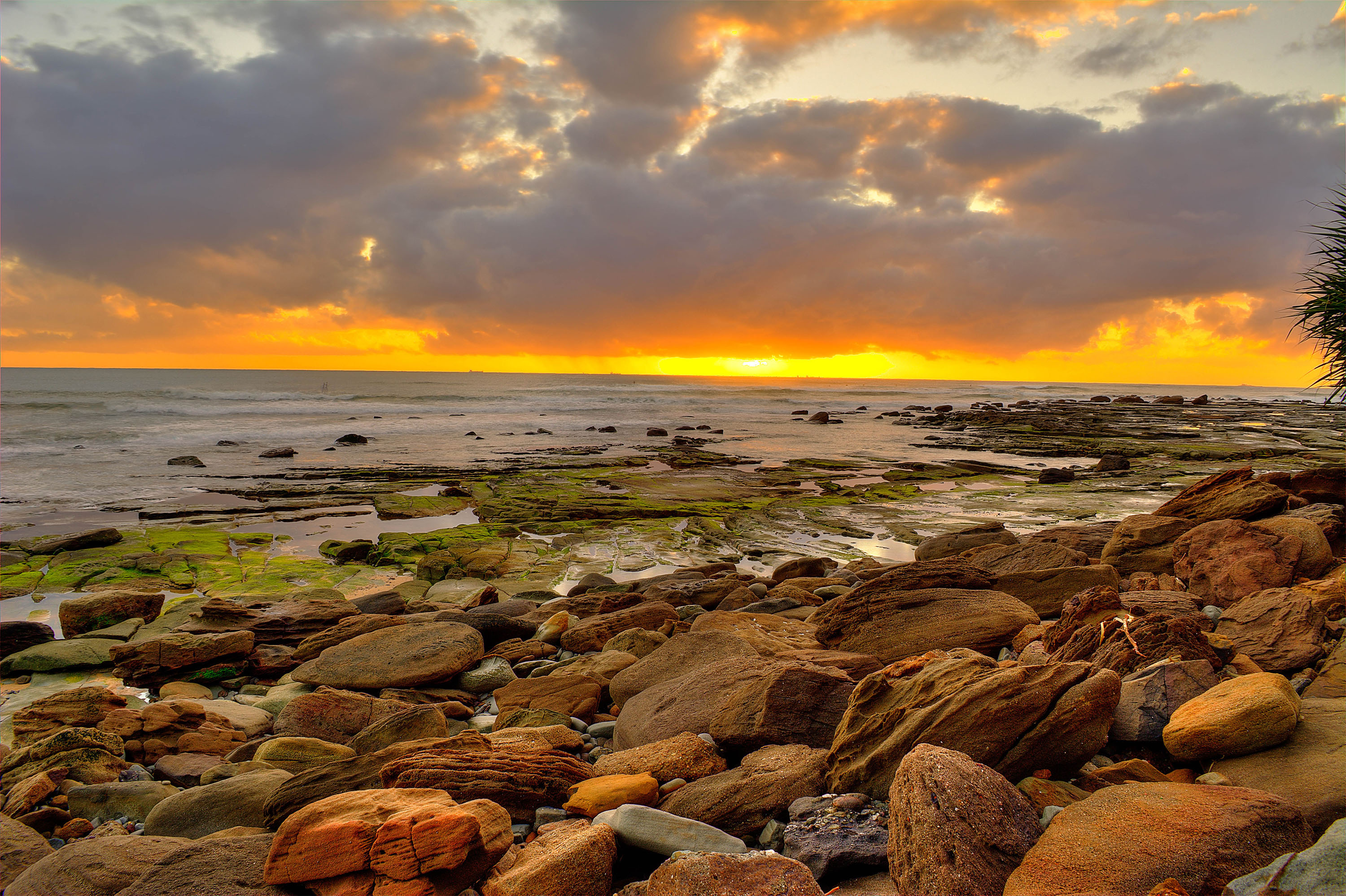 Sunrise over the rocks at Moffat Beach