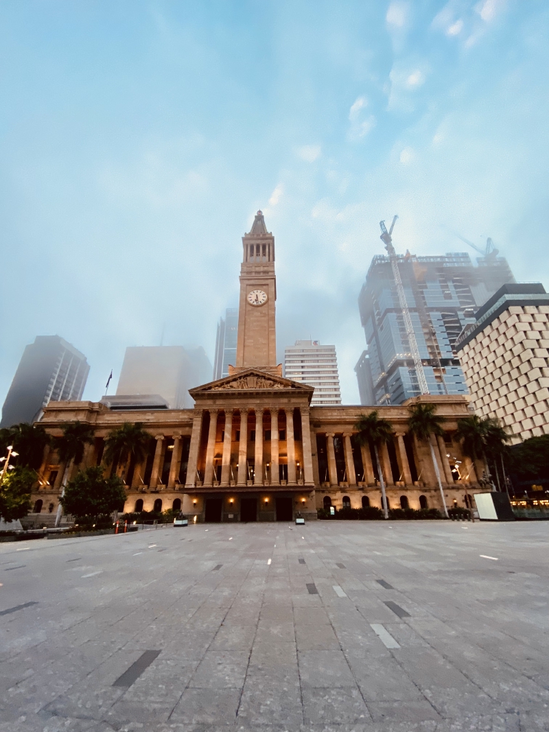 Early morning low fog over King George Square and Brisbane City Hall. Brisbane, Queensland, Australia. 14 August 2021